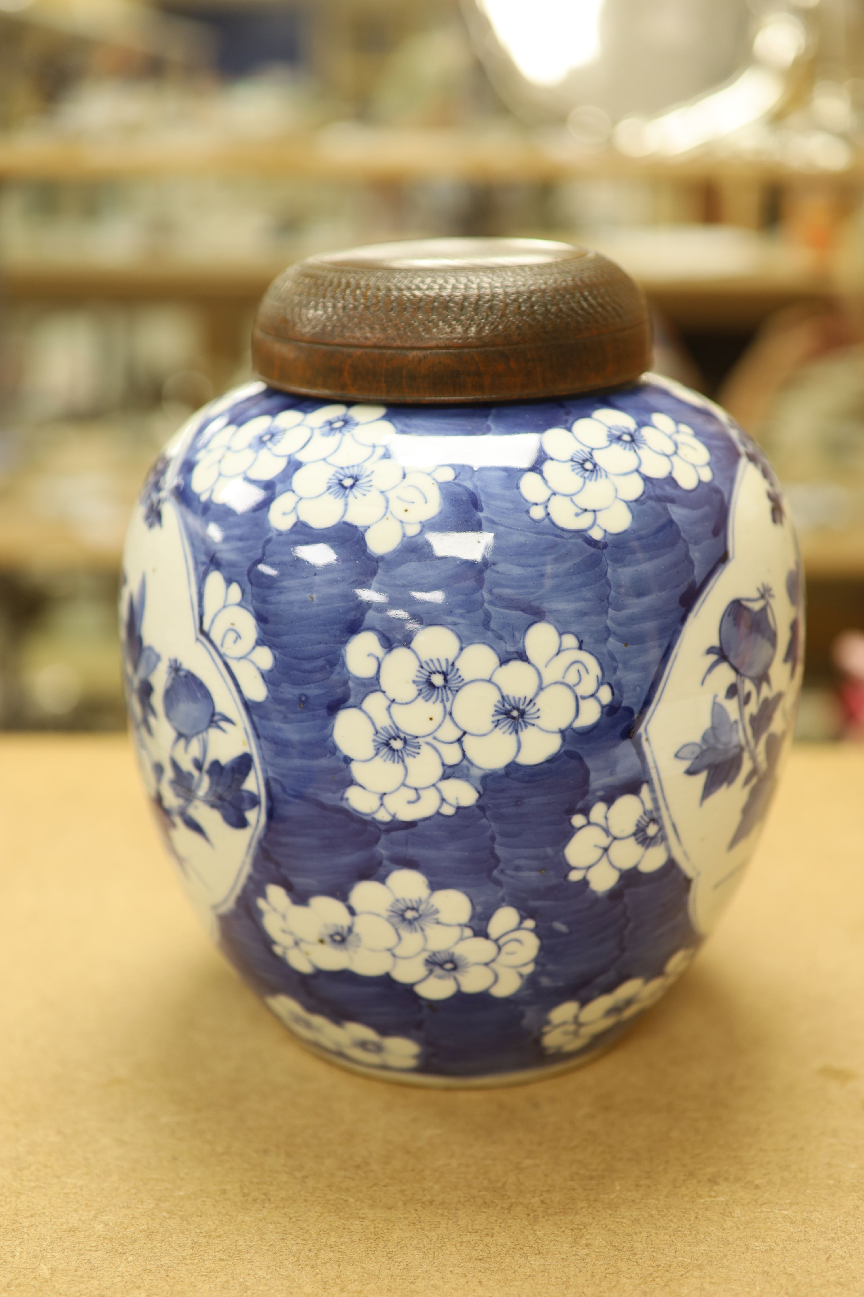 A late 19th / early 20th century Chinese blue and white jar, with wooden cover, height 25cm